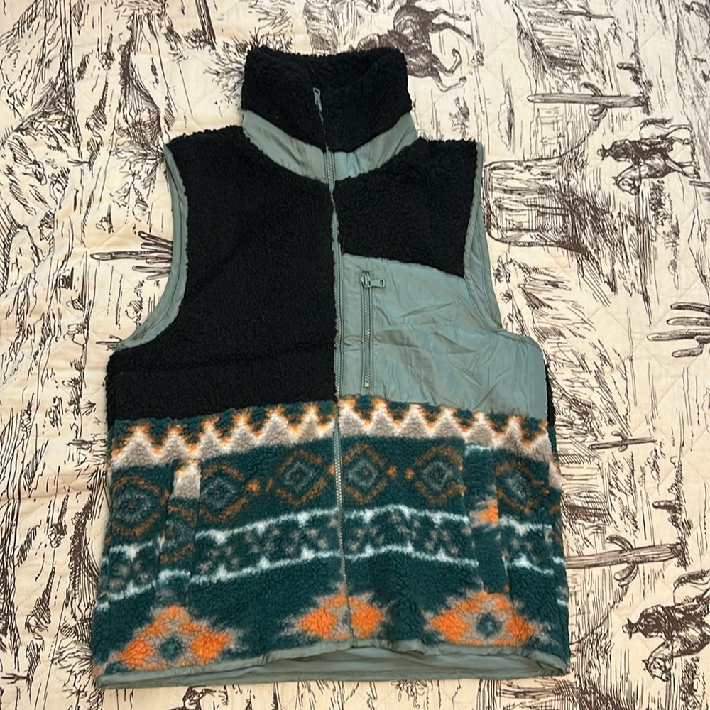 Olive green vest with fleece design. Size says small but fits like a medium.